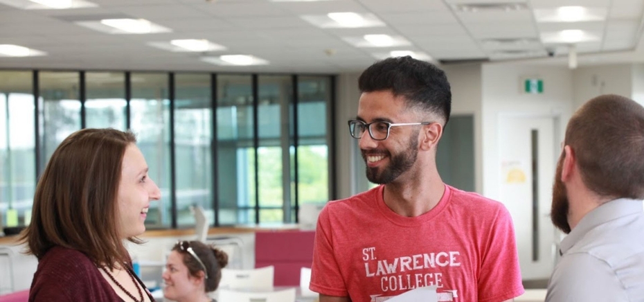 A student smiles as they speak with an SLC employee in the Kingston Student Services Centre